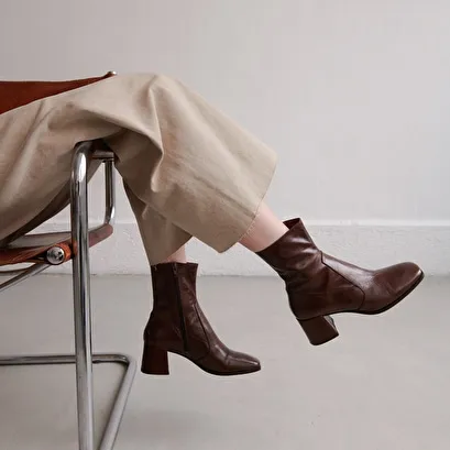 Oval-toe boots in brown aged leather