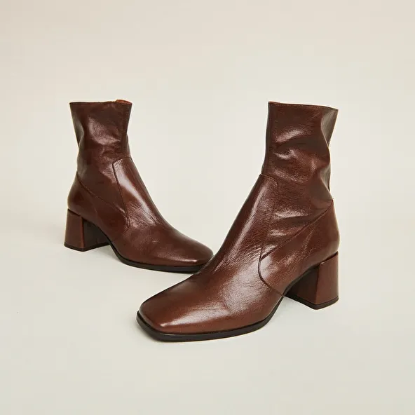 Oval-toe boots in brown aged leather