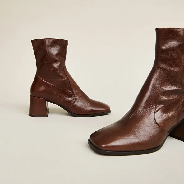 Oval-toe boots in brown aged leather